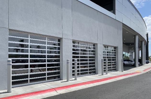 Centennial Subaru dealership exterior with multiple glass garage doors